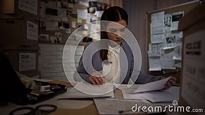 Hardworking female investigator trying to find clue to robbery solution, law Stock Photo