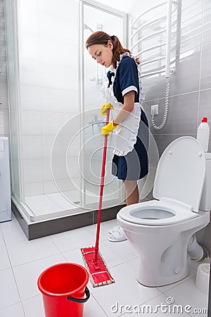 Hardworking hotel employee mopping the floor Stock Photo