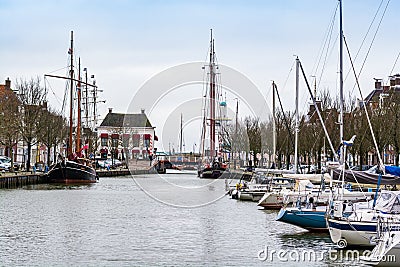 Harlingen, Nethrelands - January 10, 2020. Boats in water canal in downtown in winter Editorial Stock Photo