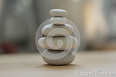 Harmony and balance, cairns, simple poise pebbles on wooden light white gray background, simplicity rock zen sculpture Stock Photo