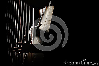 Harp player. Harpist hands playing Irish harp strings Stock Photo