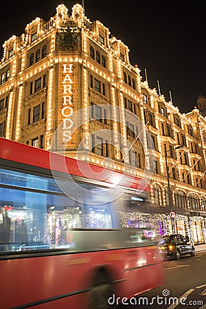 Harrods department store. Red bus passes in front of the building Editorial Stock Photo