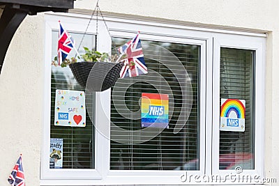 HARROW, UNITED KINGDOM - May 09, 2020: Children\'s drawing on house window with positive messages for the NHS workers during the Editorial Stock Photo