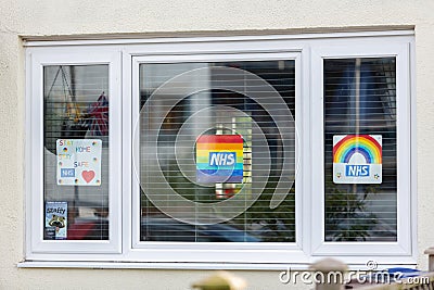 HARROW, UNITED KINGDOM - May 09, 2020: Children\'s drawing on house window with positive messages for the NHS workers during the Editorial Stock Photo