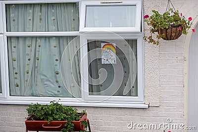 HARROW, UNITED KINGDOM - May 09, 2020: Children\'s drawing on house window with positive messages for the NHS workers during the Editorial Stock Photo