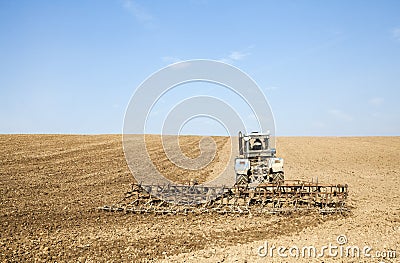 Harrowing the soil with tine harrows Stock Photo