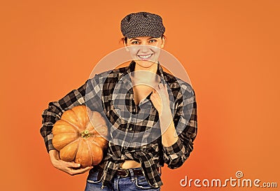 Harvest in garden. Homegrown pumpkin. Organic farming. Family farm. Woman rustic farmer presenting pumpkin. Farming and Stock Photo