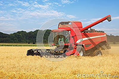 Harvester on wheat field, harvesting Editorial Stock Photo