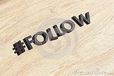 a hashtag follow, web internet like and share buttons, cut letters word, flat lay Stock Photo