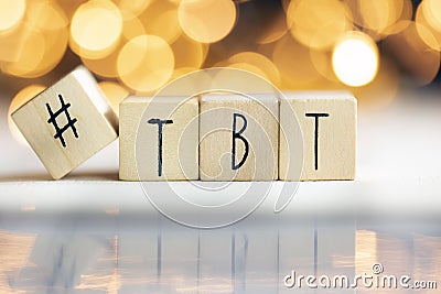 Hashtag TBT throwback Thursday written with wooden cubes with shiny bokeh background, social media concept Stock Photo