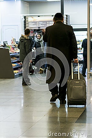 Hasid airport. orthodox with a suitcase is going around the airport Editorial Stock Photo