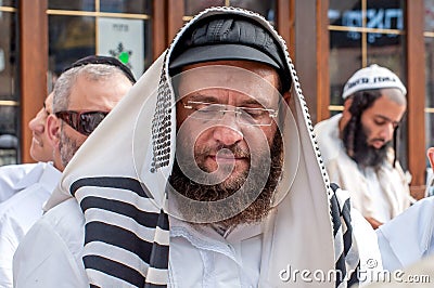 Hasids pilgrims in traditional clothes. Tallith - jewish prayer shawl. Rosh-ha-Shana festival, Jewish New Year. Editorial Stock Photo