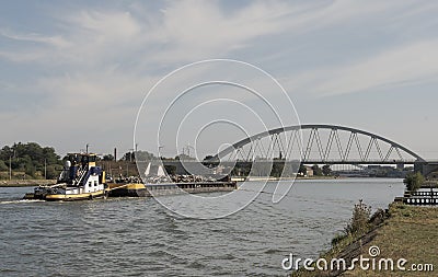 The barge transports scrap metal along the water channel. Copy space Editorial Stock Photo