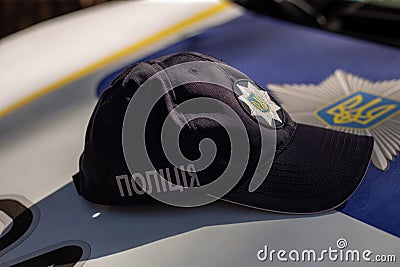 Hat of the ukrainian policeman with sign Police in ukrainian laguage and logo of police department Editorial Stock Photo