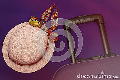 Hat and suitcase on a lilac background tourism travel Stock Photo