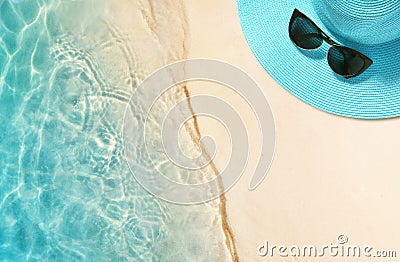 Hat and sunglasses on the sandy beach. Summer background Stock Photo