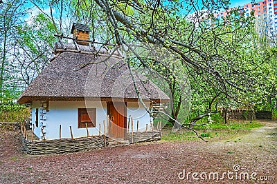 The hata house behind the branches, Mamajeva Sloboda Cossack Village, Kyiv, Ukraine Stock Photo