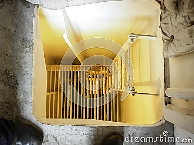 A hatch with a ladder to descend to the next level. Stock Photo