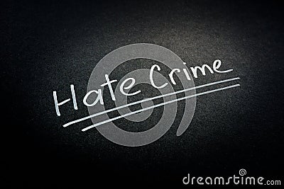 Hate crime words on the dark surface. Stock Photo