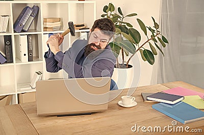 hate my job. dealing with error. overworked man crush laptop with hammer. frustrated computer user. businessman express Stock Photo
