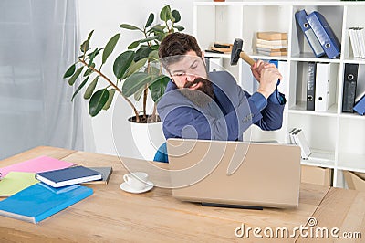 Hate my job. dealing with error. overworked man crush laptop with hammer. frustrated computer user. businessman express Stock Photo