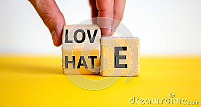 From hate to love symbol. Hand turns the cube and changes the word 'hate' to 'love'. Stock Photo