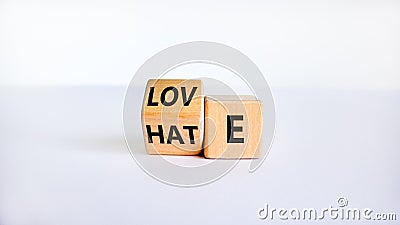 From hate to love symbol. Turned the wooden cube and changed the word `hate` to `love`. Beautiful white table, white backgroun Stock Photo