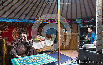 Young mongolian nomad family in their home ger yurt Editorial Stock Photo