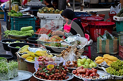 Lady sells fresh fruit & vegetables at street market bazaar Hatyai Thailand Editorial Stock Photo
