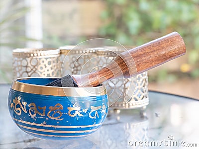 Haulerwijk - march 07 2020: Haulerwijk, The Netherlands. blue and golden indian singing bowl made of seven metals with a Stock Photo