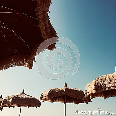 Haulm sunshades blue skys Italy sunny beach Stock Photo