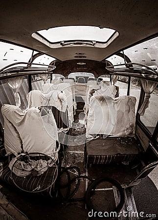 Haunted old bus with ghosts, murder scene, apocalyptic vision with blood covered sheets on seats and bench seats Stock Photo