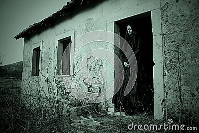 Haunted woman in black dress Stock Photo