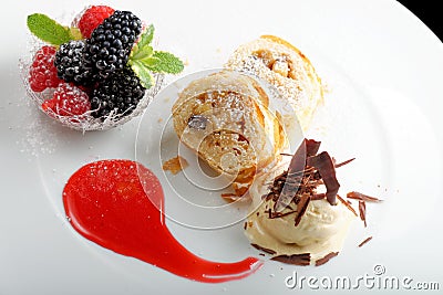 Haute cuisine, strudel with ice cream and berries dessert on restaurant table Stock Photo