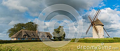 View of the historic windmill Moulin de Pierre and miller`s house in Hauville in Normandy Stock Photo