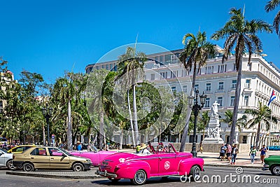 Havana, Cuba - Mar 10th 2018 - Amazing pink car driving through a touristic area of Havana, Cuba Editorial Stock Photo