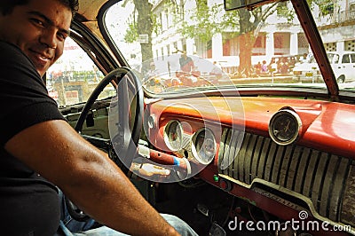 HAVANA, CUBA - MAY 31, 2013 Young Cuban male sitting in old classic american car in Havana,Cuba. Cuba is known for the beauty Editorial Stock Photo