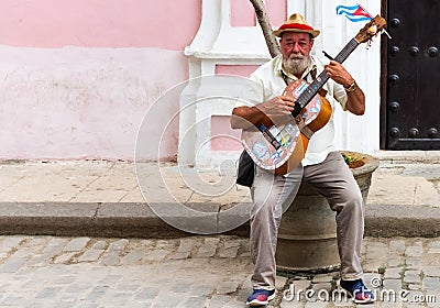 Cuban street musician plays on his guitar for money in Havana City Cuba - Serie Cuba Reportage Editorial Stock Photo