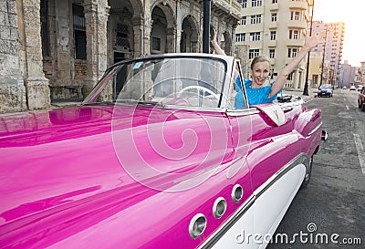 HAVANA- JANUARY 27, 2013: The beautiful woman at a wheel old American retro car 50th years of the last century, an iconic sight Editorial Stock Photo