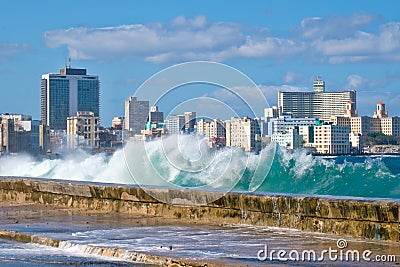 Havana skyline with waves crashing on the Malecon seawall Stock Photo