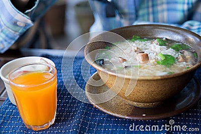 Have breakfast with rice soup and orange juice Stock Photo