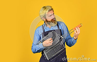 Have fun enjoy cooking. Tools roasting meat. Man in apron hold barbecue grill. Bbq food. Culinary concept. Cooking Stock Photo