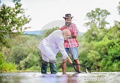 Have fun. Fishermen. successful catch. retired businessman. male friendship. Good profit. granddad and drandson fishing Stock Photo