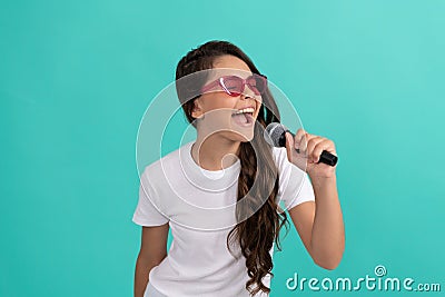 Have fun at karaoke. Karaoke child singer blue background. Happy kid sing into microphone. music. Stock Photo