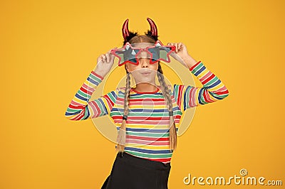Have funny Halloween. Party girl look through funny star shaped glasses. Funny child with spooky look. Creepy and funny Stock Photo