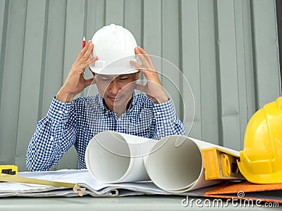 Have stress, Asia Engineer serious thinking, young man and looking away while sitting Stock Photo