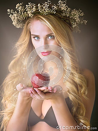 Have you fallen under the spell of her feminine charm. Studio shot of a gorgeous young woman offering a magical red Stock Photo