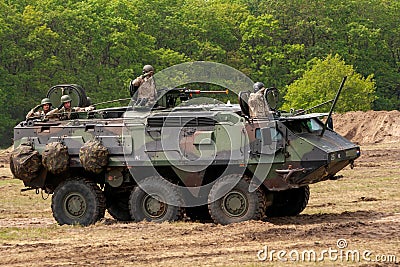 HAVELTE, NETHERLANDS - MAY 29, 2010: Dutch army soldiers inside a XA-188 Sisu Patria 6x6 wheeled armored vehicle during the Dutch Editorial Stock Photo