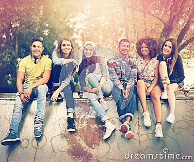 Having a chilled time at their favorite hangout. Portrait of a group of friends hanging out together in an urban setting Stock Photo