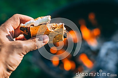 Having a s`more over the fire in the summer Stock Photo